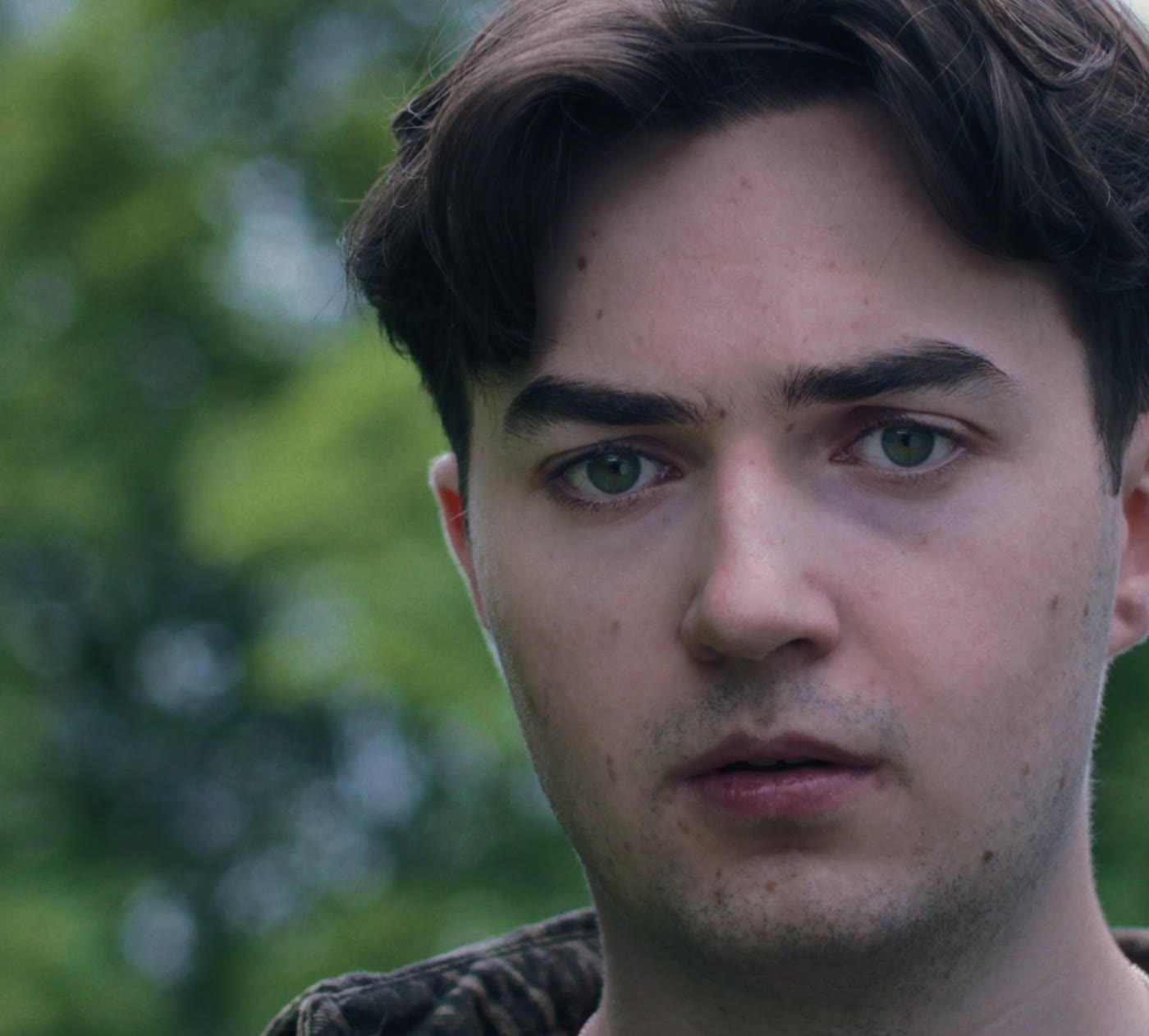 A young man in a park, close up